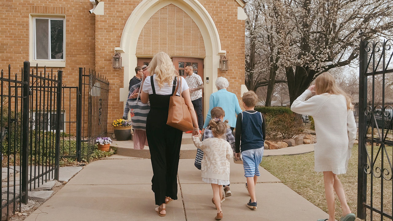 A family walks up to the Seed Church building.